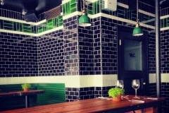 Deep blue field tiles with olive upper border and pale yellow lower band