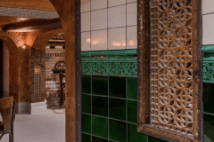 Mixed shades of emerald with tulip border and dado. Aged craquelle engobe 6"x6" tiles above