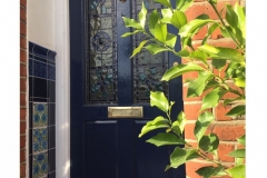 Deep blue porch tiles with William De Morgan Bedford Park insets
