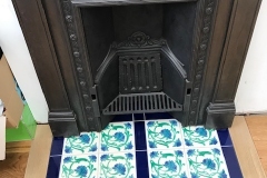 Hearth tiles incorporating tubelined floral tiles set in a deep blue border