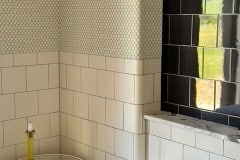 Matt white and grey tiles utilising curved corners