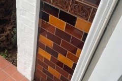 Mixed shades of brown porch tiles with tulip border