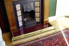 Decorative fireplace tiles with burgundy hearth