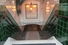 Mixed shades of emerald with tulip border and dado. Aged craquelle engobe 6"x6" tiles above