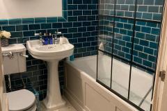 Turquoise bathroom tiles with skirting and dado