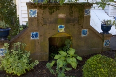 Variety of William De Morgan tiles set in garden