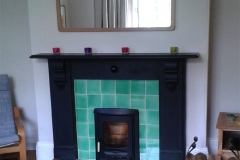 Pale green fireplace surround tiles