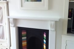 Multicoloured inset fireplace tiles