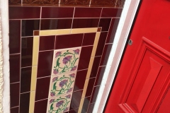 Burgundy storm porch tiles with tulip border, skirting and dado, with central tube lined panel