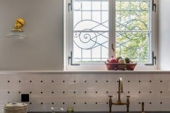Tin white tiles with clipped corners to accept cast iron studs. Tiles set in diamond pattern. Bespoke design and make by Artichoke Ltd. Photography: Emma Lewis