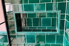 Shower niche set into 6X6" caspian tiles with square external corner.