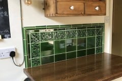 Olive splashback with tulip border and dado surround.