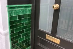 Emerald green porch using 6"x3" tiles, with skirting, tulip border and dado