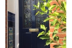 Deep-blue-porch-tiles-with-William-De-Morgan-Bedford-Park-Insets