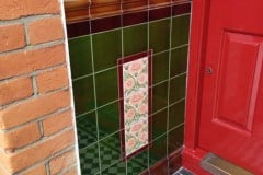 Olive green porch entrance with William De Morgan floral feature tiles