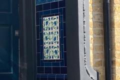 Deep blue porch entrance with tubelined inset tiles