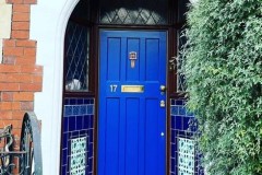 Dark blue porch tiles with marine tulip border and tubelined inset tiles