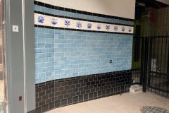 Dark grey and victorian blue with a William Morris border for an arcade entrance